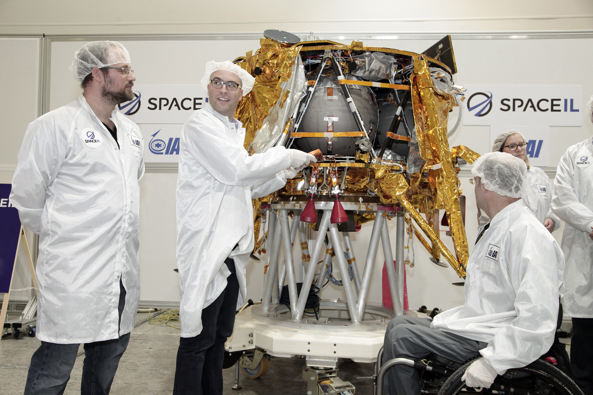 Yonatan Winetraub, one of three SpaceIL founders, inserts a time capsule into the compay&#039;s private moon lander, which is scheduled to launch in February 2019. 