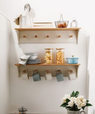 two white and wood shelves with peg hooks
