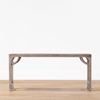 A wooden console table with curved details on each corner