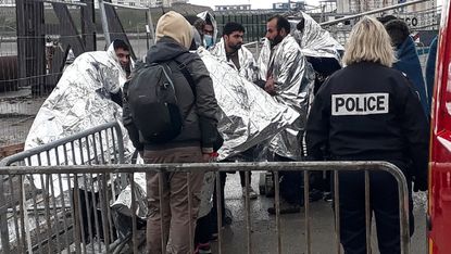 French rescue teams help a group of migrants in Calais