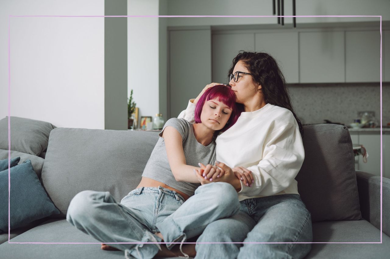 A mother hugging her son on a sofa