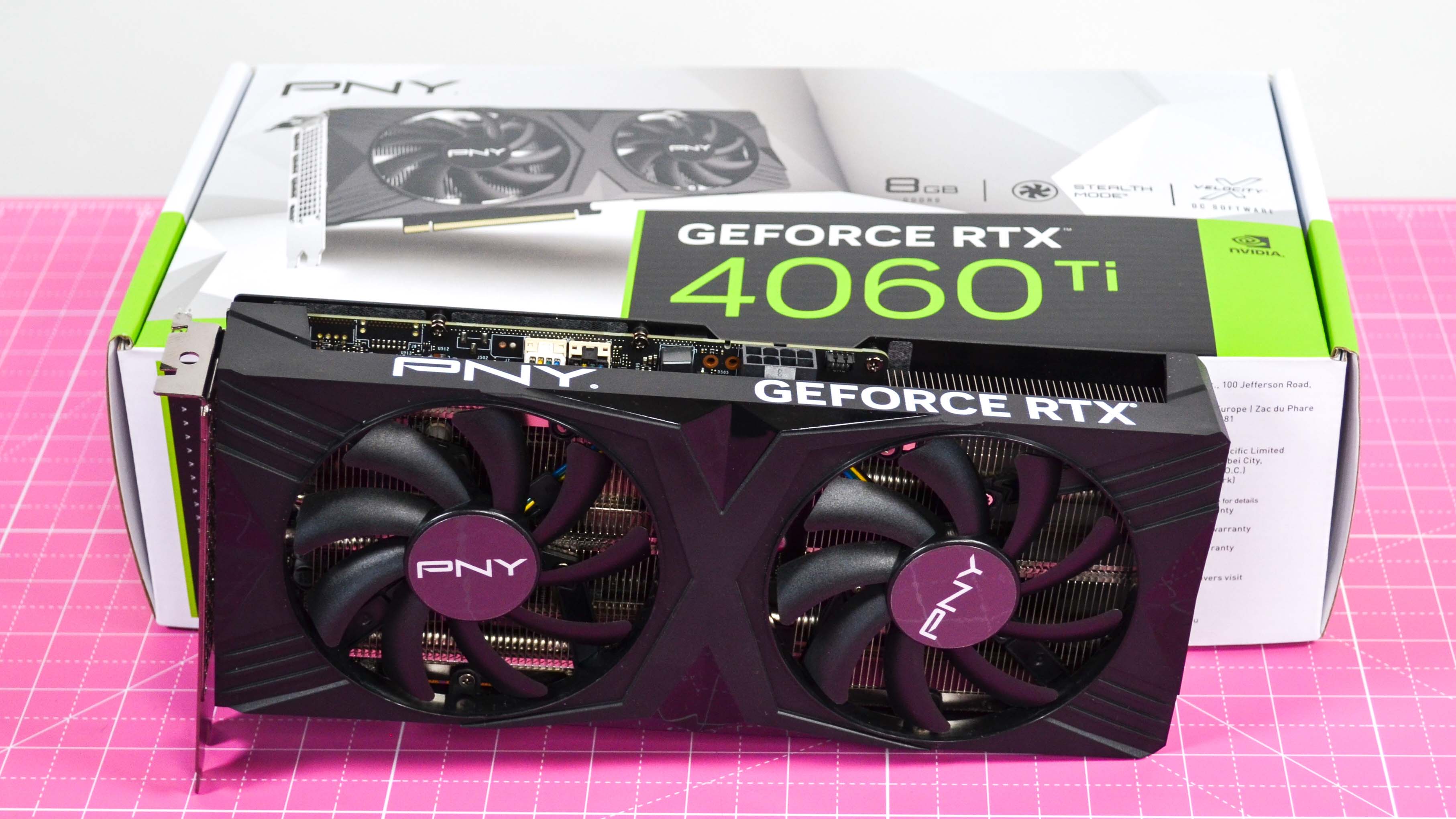 A PNY GeForce RTX 4060 Ti on a desk with a pink desk mat.