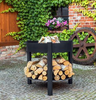 A fire pit idea with log storage