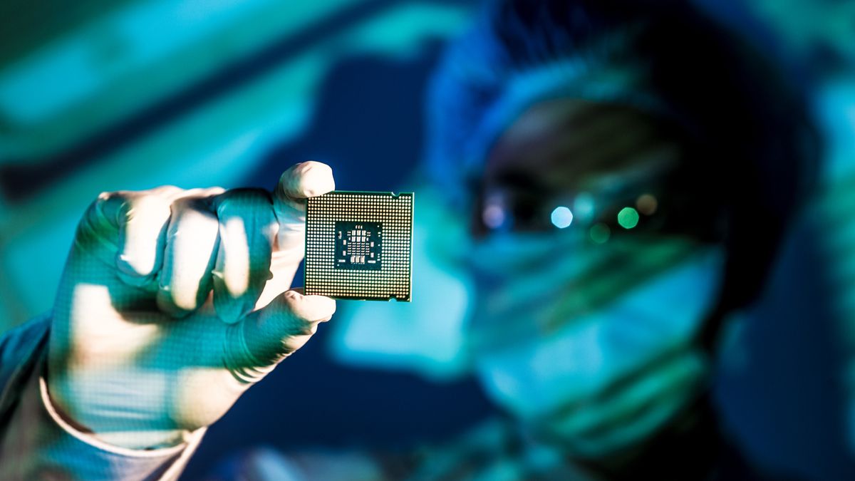 A researcher holding up a new chip