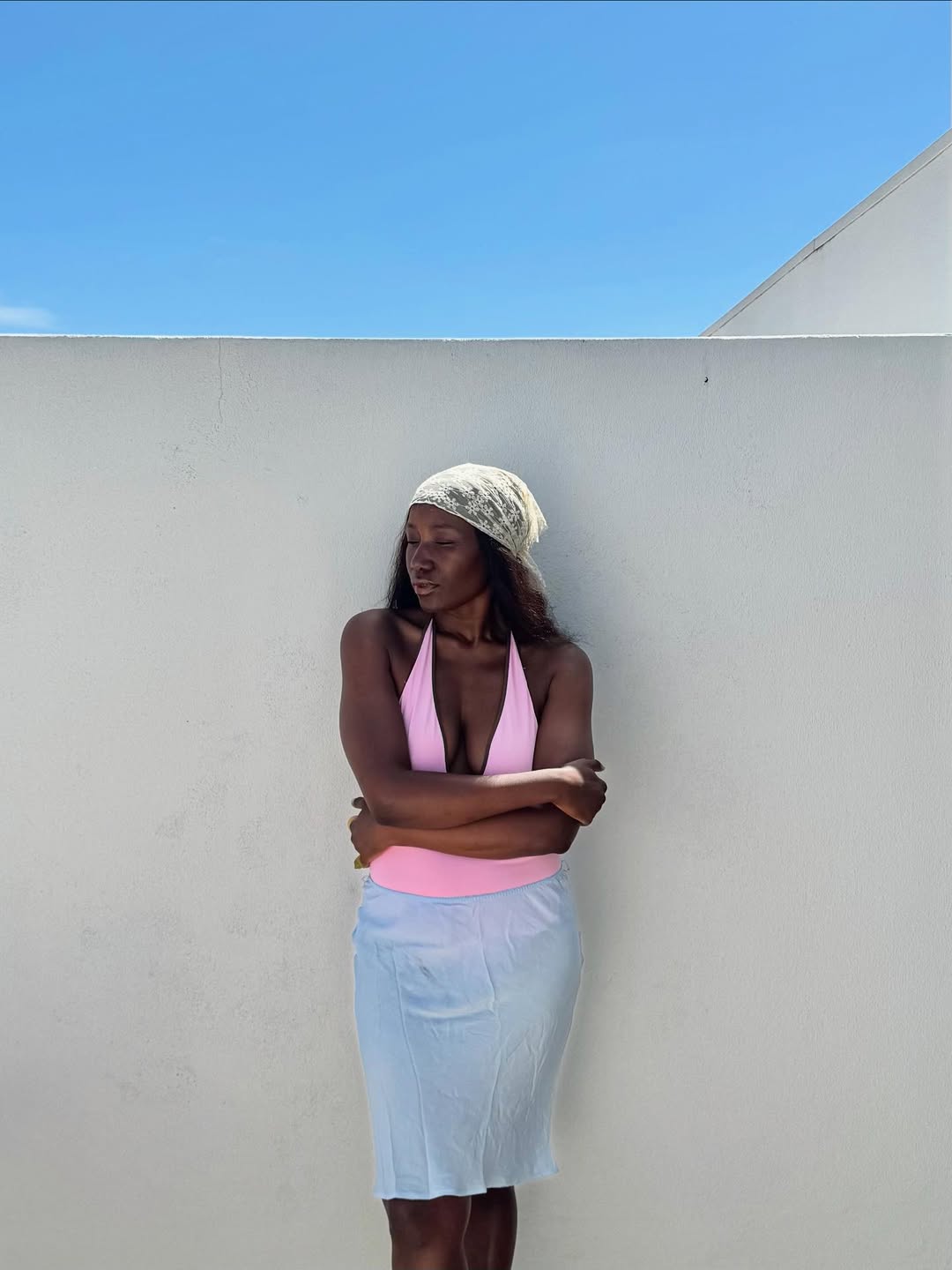 Influencer Raissa T wearing a halterneck top, midi skirt and head scarf.