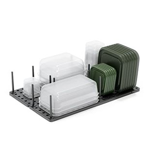 Gray peg board organizer with clear and dark green plastic containers and lids displayed