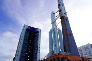 A Chinese Long March 5B rocket stands on a launchpad in front of a blue sky. The rocket will carry China's experimental Wentian module to the country's Tiangong space station.
