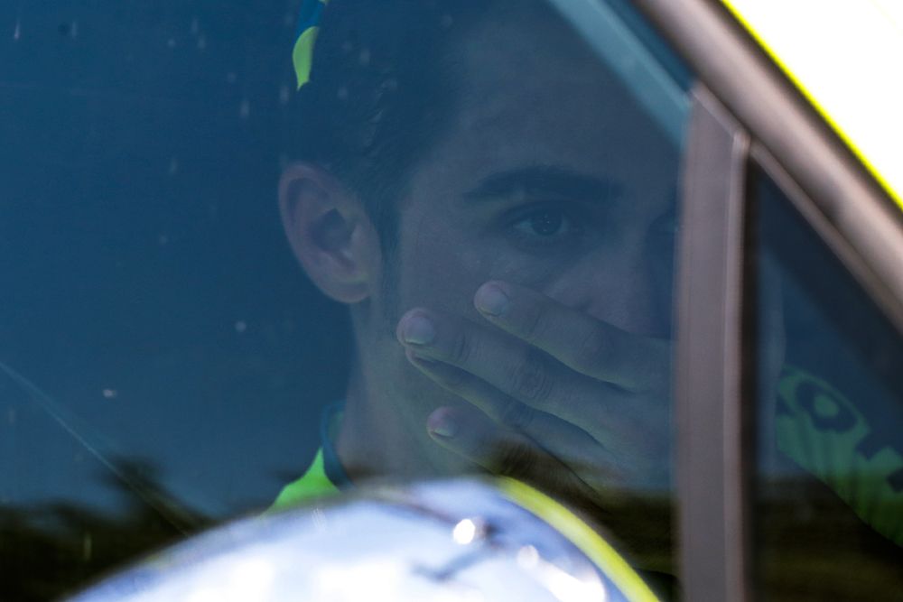 Alberto Contador sits in his team car after abandoning the Tour de France