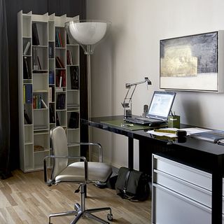 home office with white wall black desk and chair