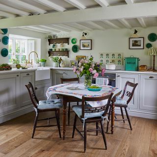 round kitchen table in a country cottage kitchen