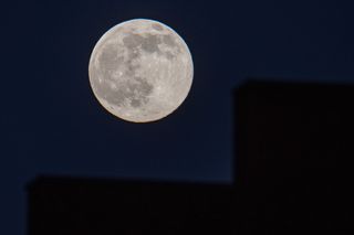 large gray full moon against the black backdrop of space.