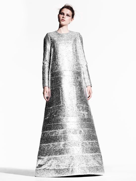 Model wearing floor length shiny silver dress