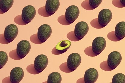 Th benefits of avocado shown in a pattern made from avocados.