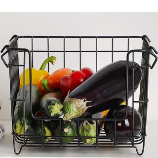 black wire kitchen storage basket with fresh veg being stored