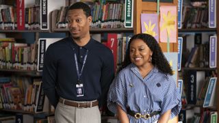 Janine Teagues (Quinta Brunson) and Gregory Eddie (Tyler James Williams) stand in front of rows of bookshelves in Aboott Elementary season 4