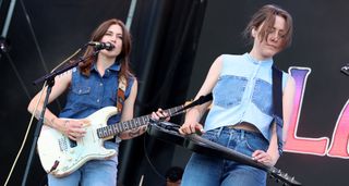 Larkin Poe play Bonnaroo Festival in 2024. Rebecca Lovell sings and plays rhythm on her Stratocaster while Megan plays her lap steel.