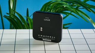 the acaia lunar coffee scale in black with an aluminum surface and accurate precise weight ideal for espresso machines given its compact size is photographed againt a blue tom's guide background