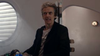 The 12th Doctor sitting in the base of a Dalek.