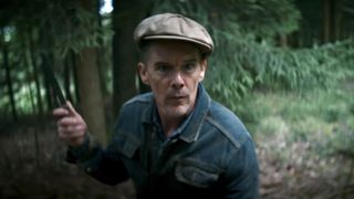 Ethan Hawke holding a knife in The Weight. 