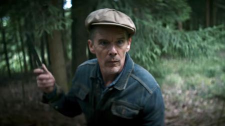 Ethan Hawke holding a knife in The Weight. 