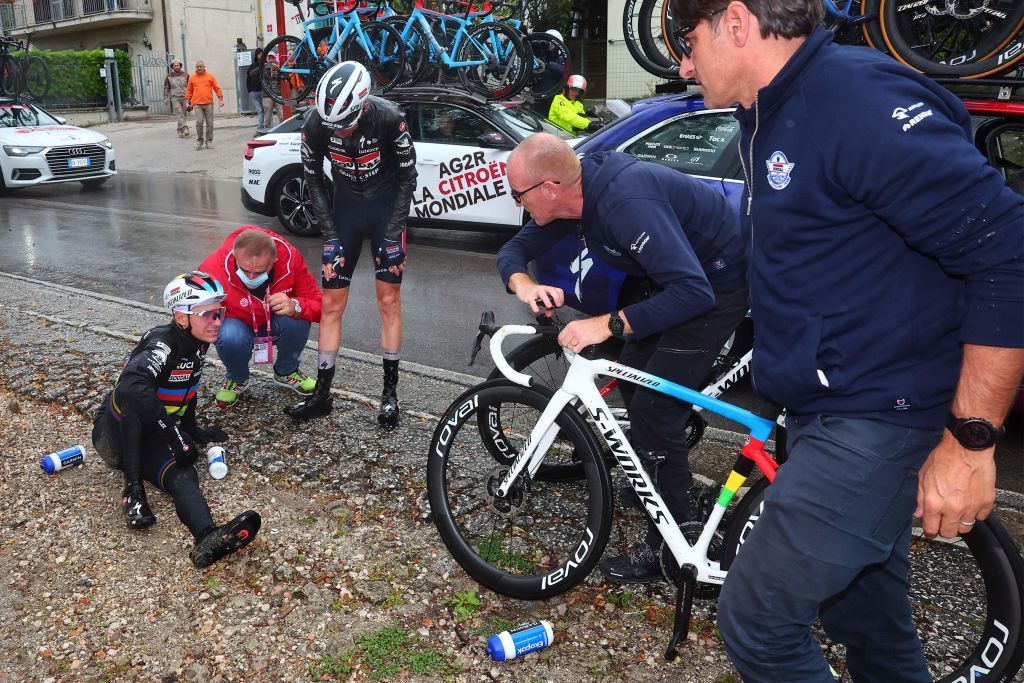 Soudal Quick Steps Belgian rider Remco Evenepoel is assisted by members of his team after crashing during the fifth stage of the Giro dItalia 2023 cycling race 171 km between Atripalda and Salerno on May 10 2023 Photo by Luca Bettini AFP Photo by LUCA BETTINIAFP via Getty Images