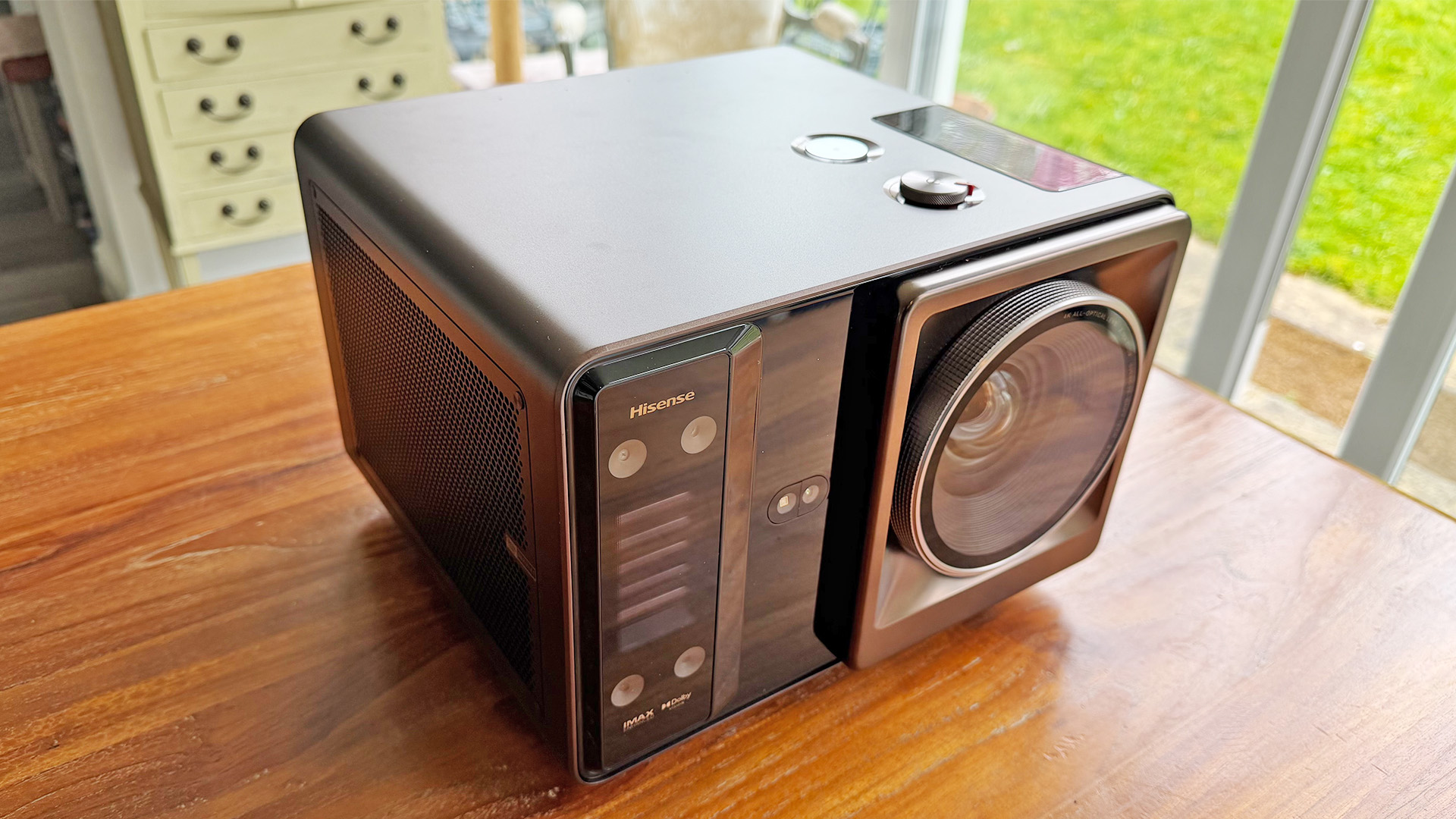 Hisense XR10 home cinema projector on wooden table