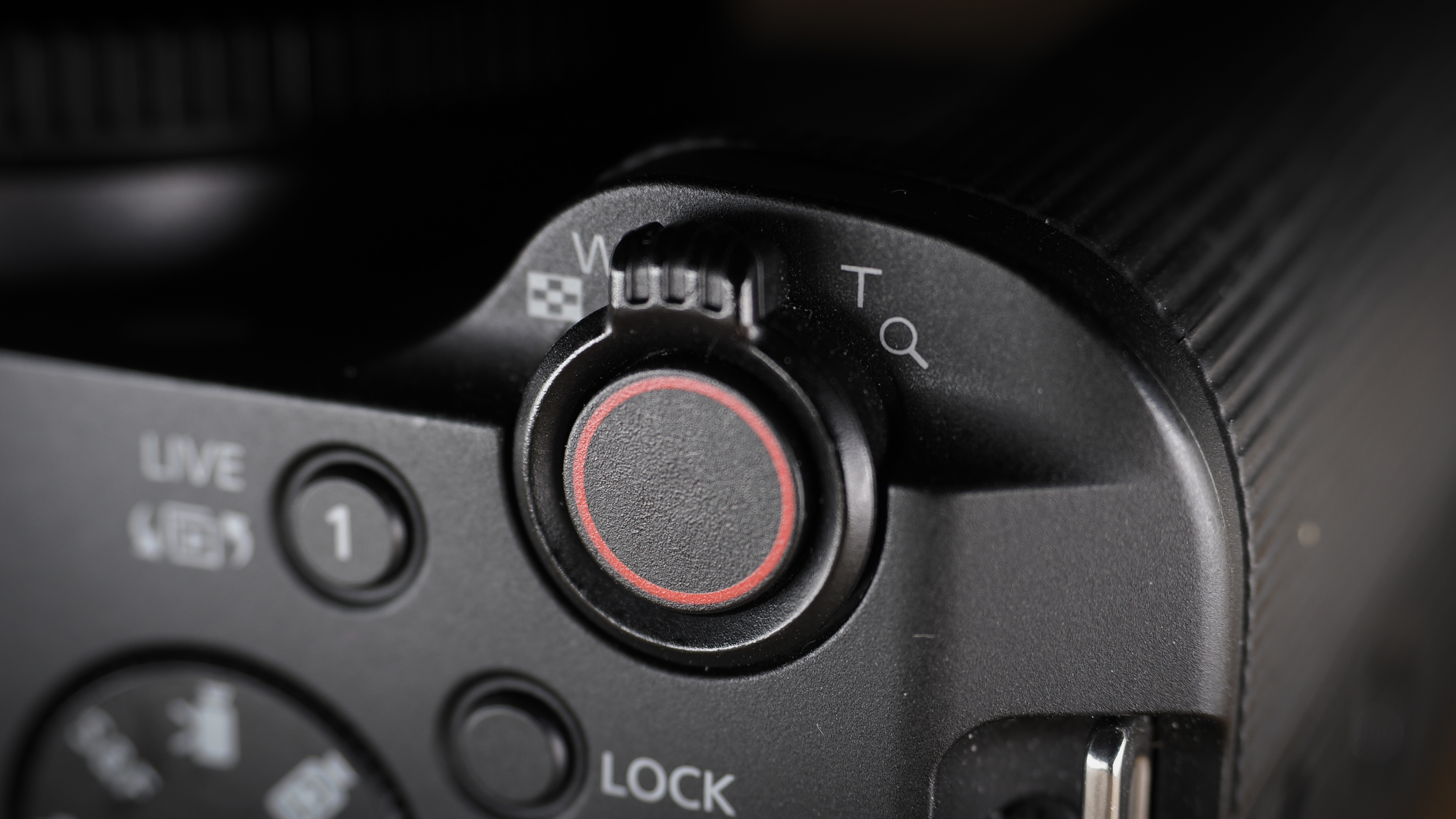 Canon EOS R50 V on a wooden surface, against a dark background