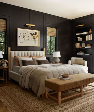 Black bedroom with bed, artwork and shelving on walls