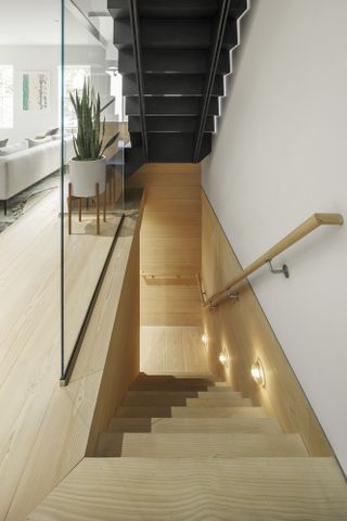 Metal and wood feature staircase at the OverUnder House in Boston