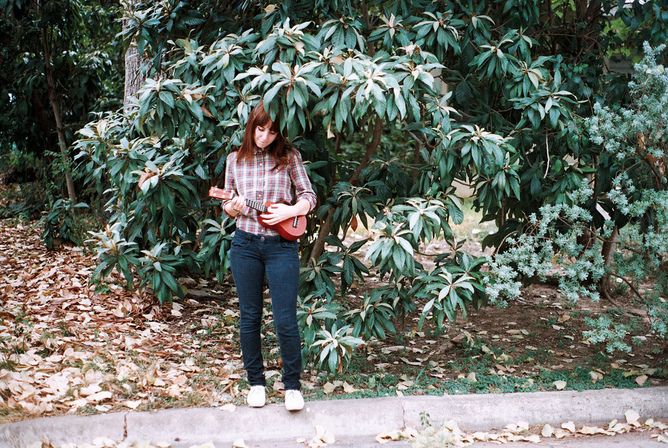 Hipster girl playing ukelele, targeted advertising, social media