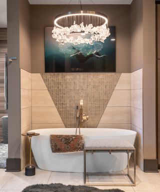 Bathroom will statement chandelier ceiling light and stand alone bathtub