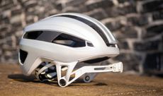 A white Canyon Highbar helmet with the strap pivoted forward