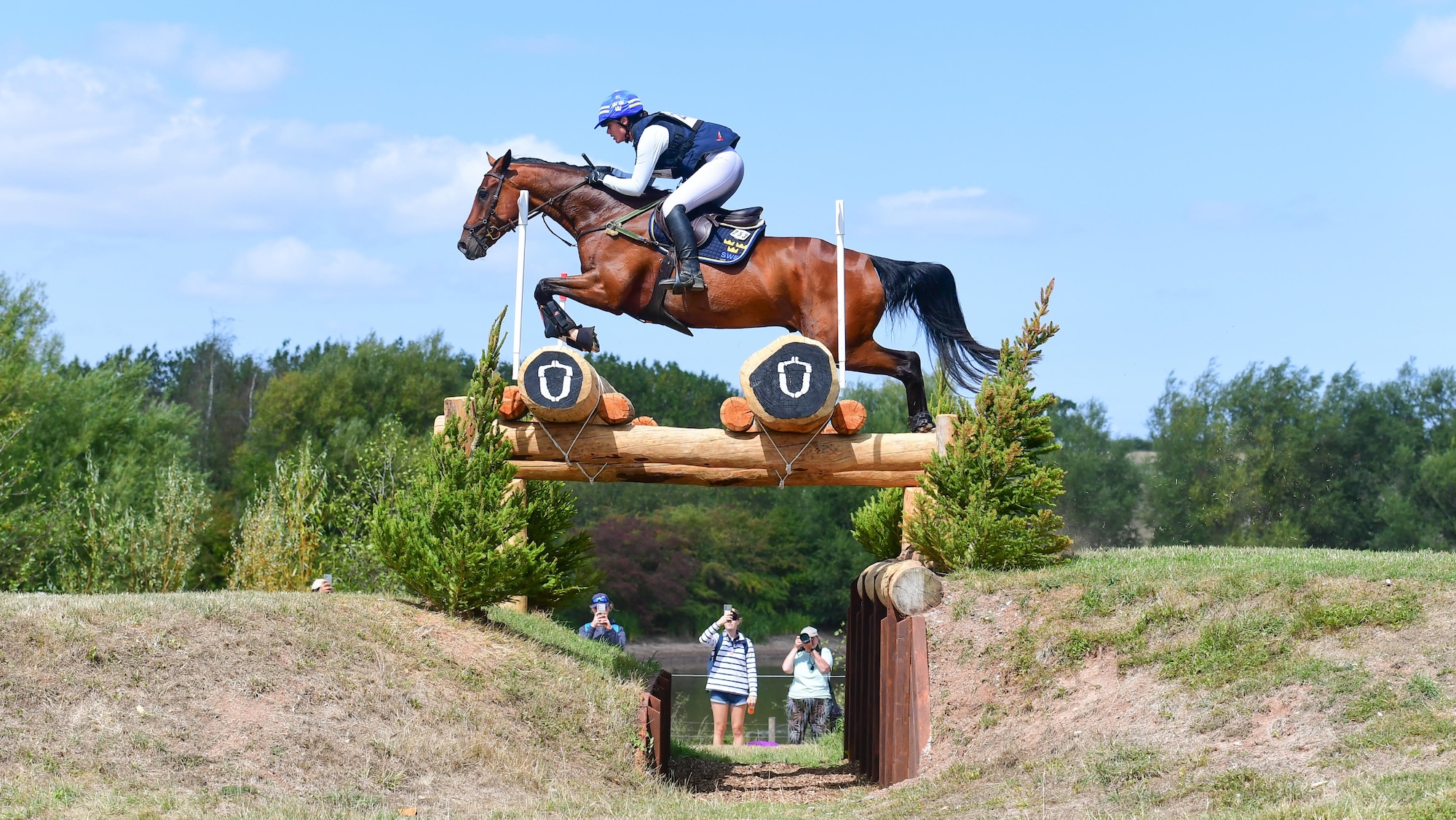 Sofia Sj&ouml;borg and bay gelding Govalent clear a ditch across country