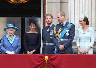 Queen Elizabeth II, Meghan, Duchess of Sussex, Prince Harry, Duke of Sussex, Prince William, Duke of Cambridge and Catherine, Duchess of Cambridge watch the RAF flypast