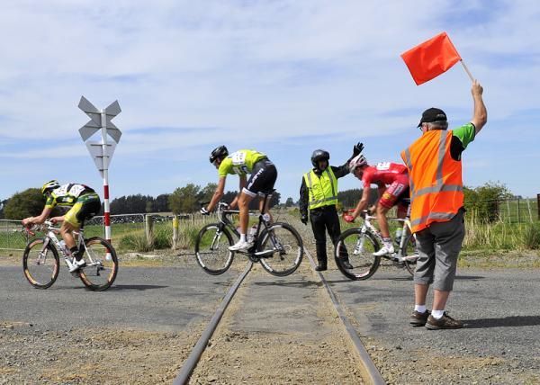 Race director Bruce Ross warns riders of a dangerous railway crossing.