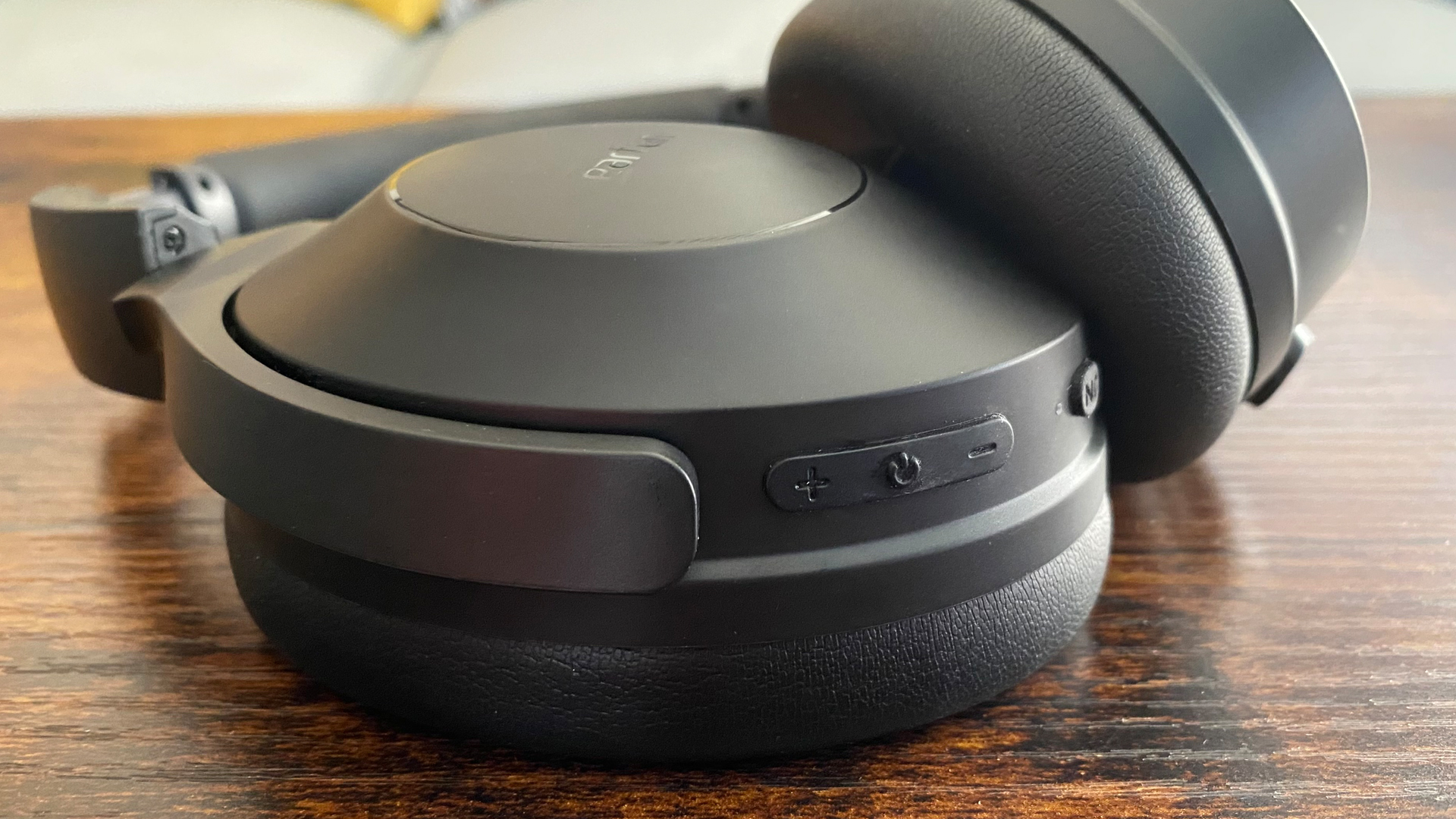 Earfun Wave Life over-ear noise-cancelling headphones on a wooden surface