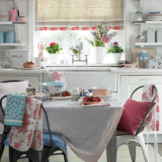 kitchen with white window and floral crockery