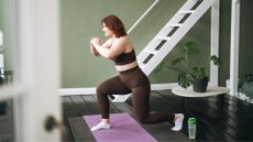 Woman doing deep core exercises on yoga mat at home
