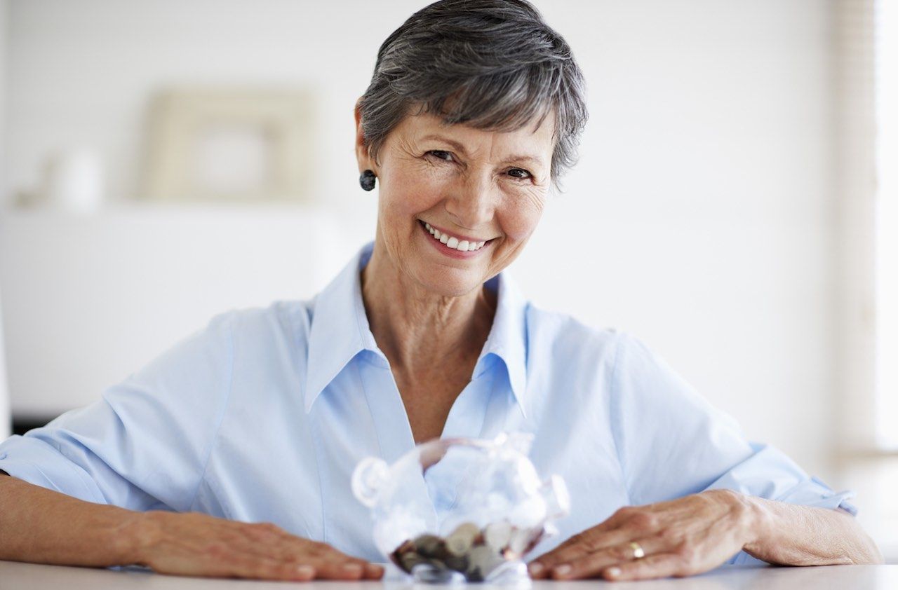 Senior Woman with Piggy Bank