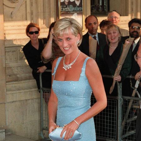 Princess Diana wears a shimmering blue mini dress and carries a matching blue silk clutch bag