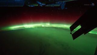 This view of the aurora, or Northern Lights, was taken by astronauts aboard the International Space Station in early 2012. It shows brilliant aurora displays dancing above Earth.