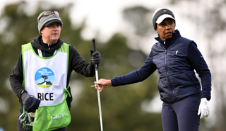 Condoleezza Rice hands her club to her caddie