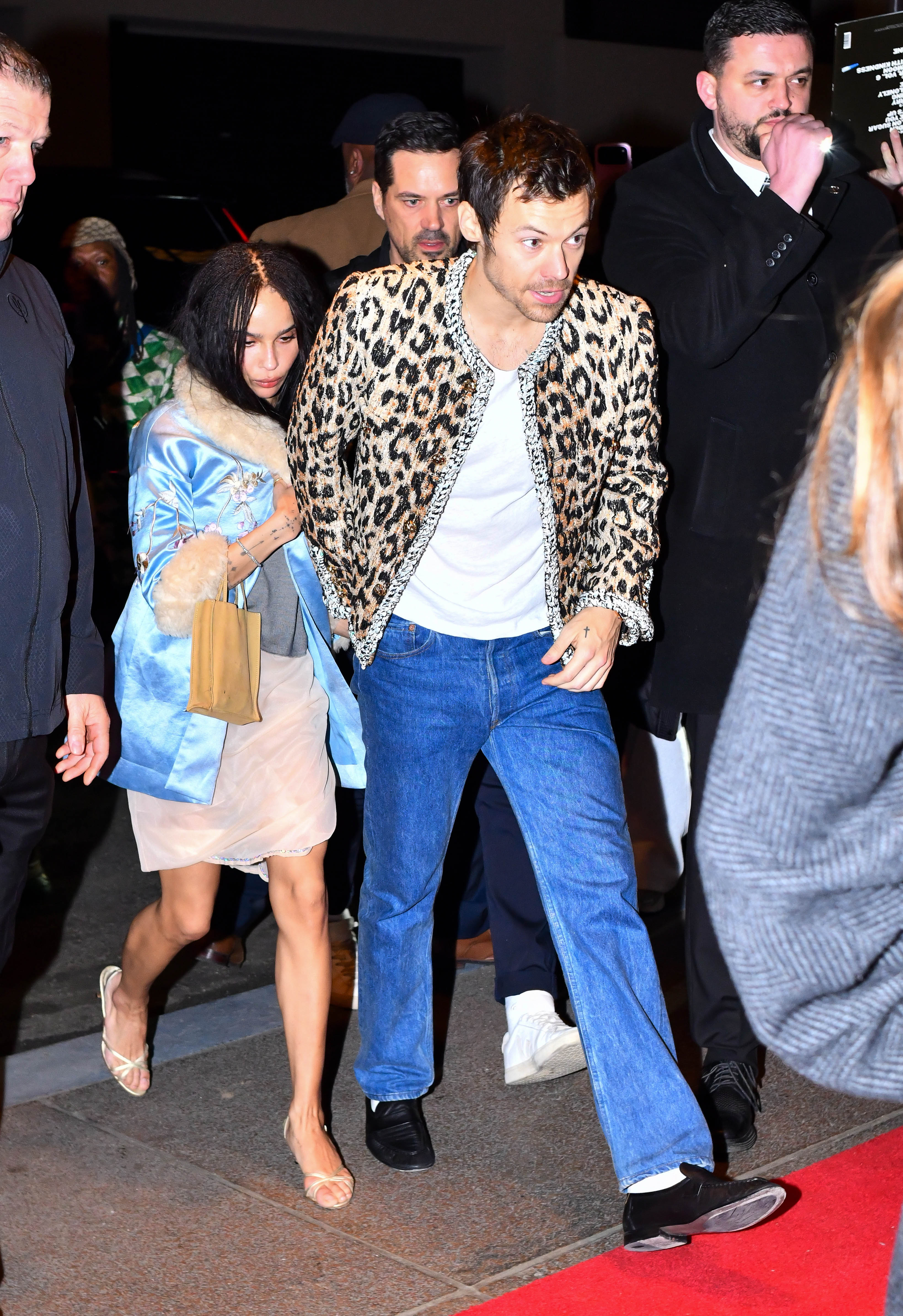 03/15/2026 Harry Styles and Zoe Kravitz are spotted heading to the SNL afterparty in New York City. The 32 year old singer looked stylish wearing an animal print jacket and denim jeans while Zoe wore a light blue silk coat over a white dress paired with heels
