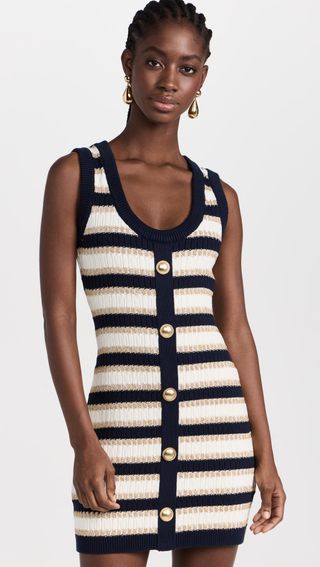 model wears short knit striped dress with gold accent buttons 