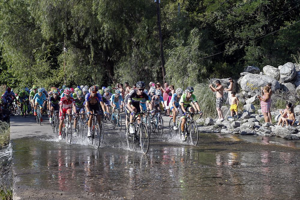 Riders make their way through a wet patch on the stage 6 route