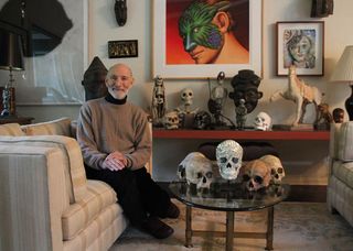Richard Harris in his home alongside his skull collection.