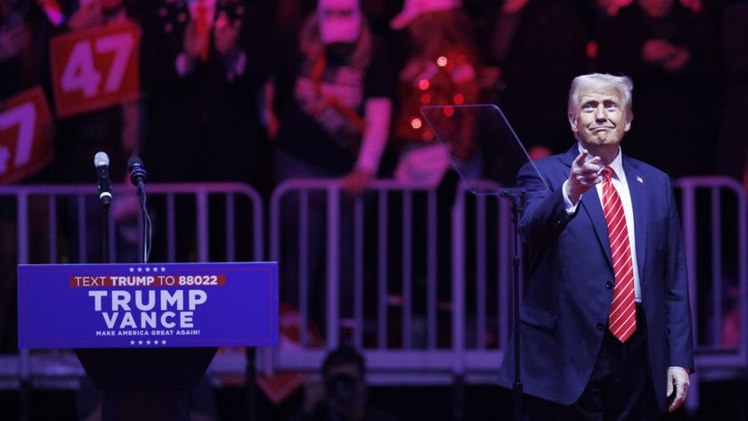 Donald Trump stands on stage at a rally the day before his inauguration