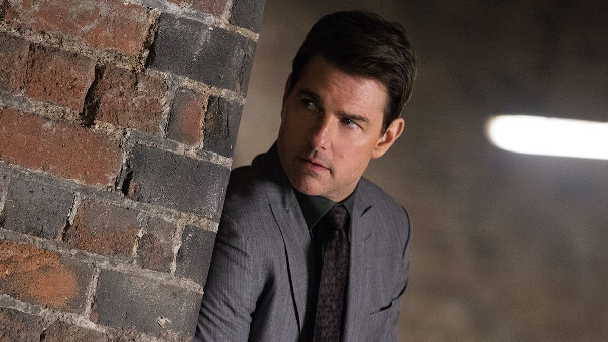 Tom Cruise peering past brick wall in Mission: Impossible - Fallout