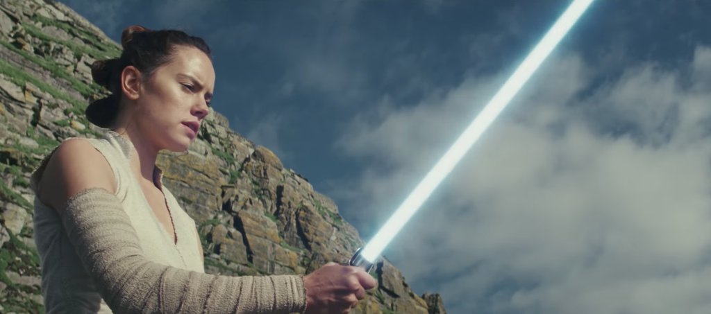 Daisy Ridley with lightsaber Star Wars: The Last Jedi