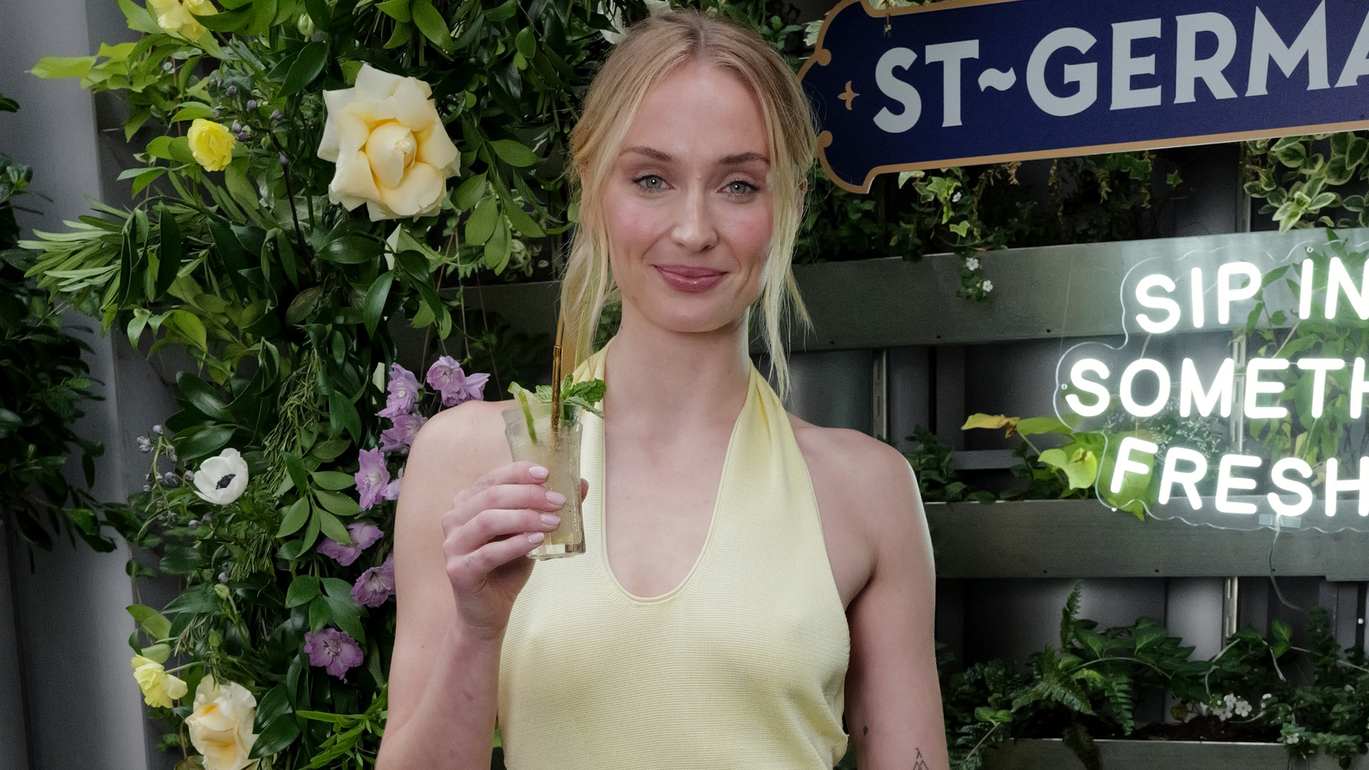 Sophie Turner styles a chic yellow sun dress in NYC.